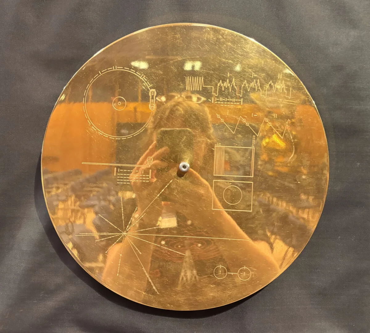 The Voyager Golden Record with author reflected in the surface